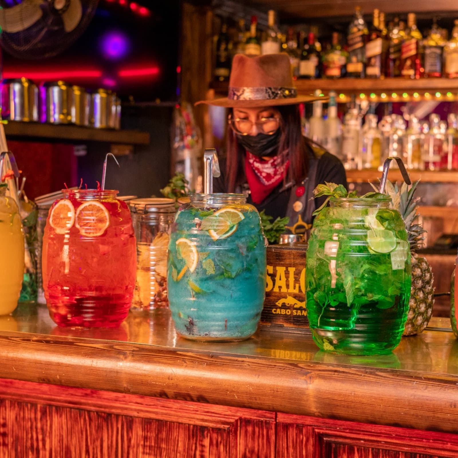 Giant colorful drink jars at Saloon Bar, a stop on the Cabo Party Pass bar crawl in downtown Cabo San Lucas