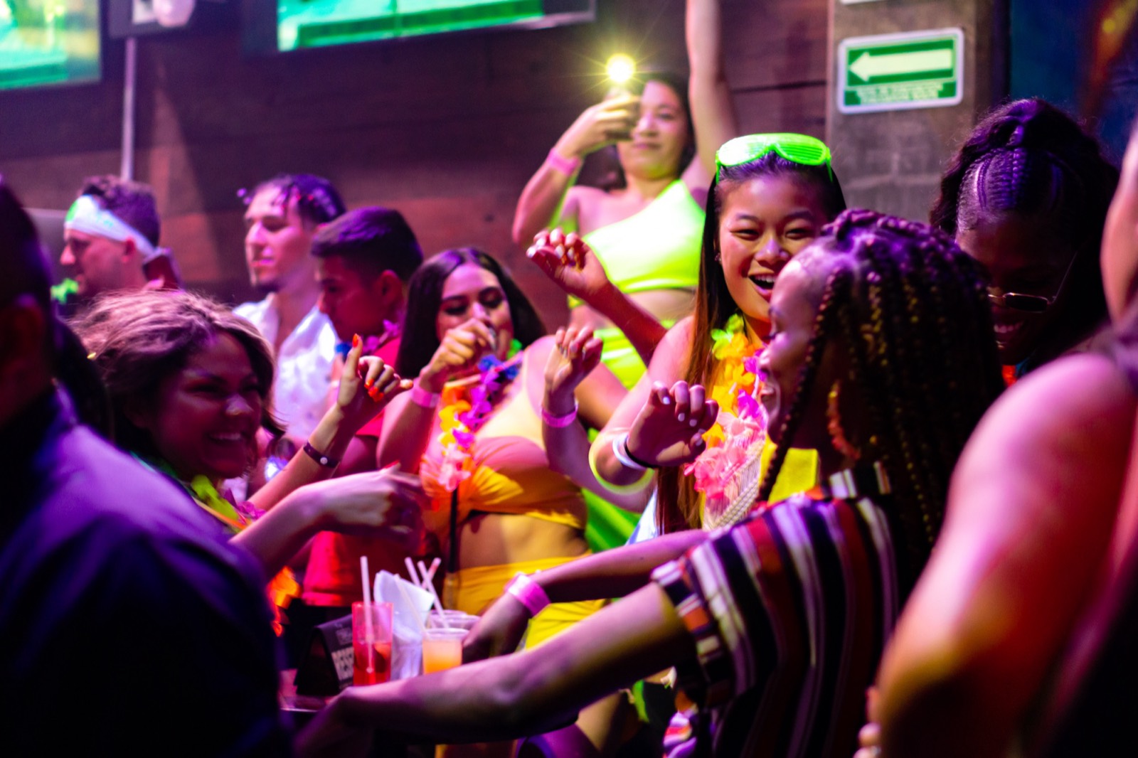 Packed spring break crowd with balloons dropping at El Squid Roe, the finale of every Cabo Party Pass night